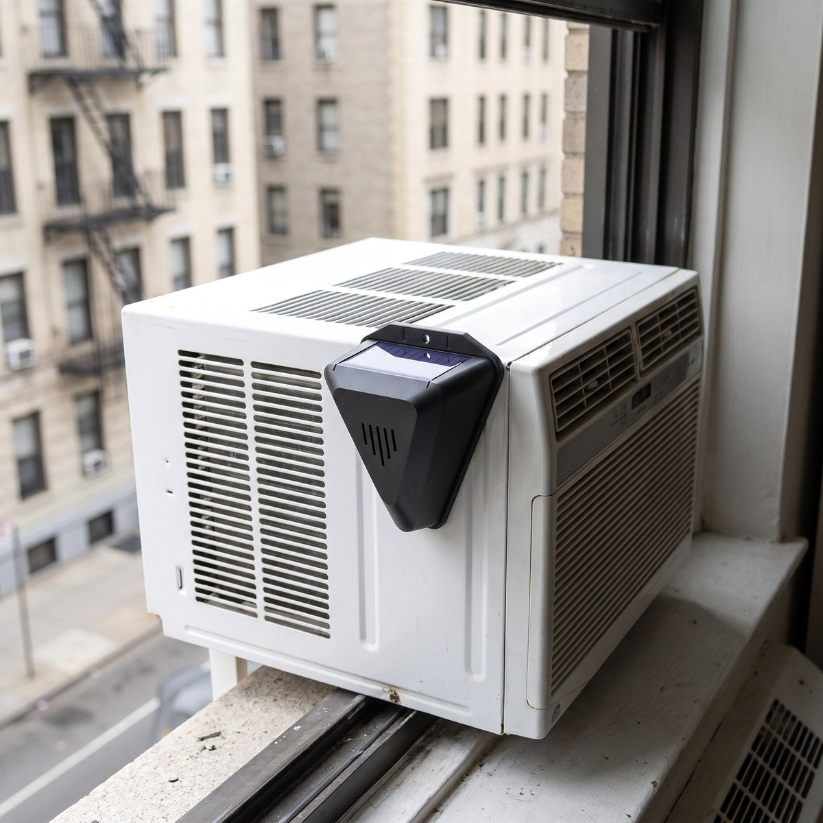 Mounted on top of a window air conditioning unit