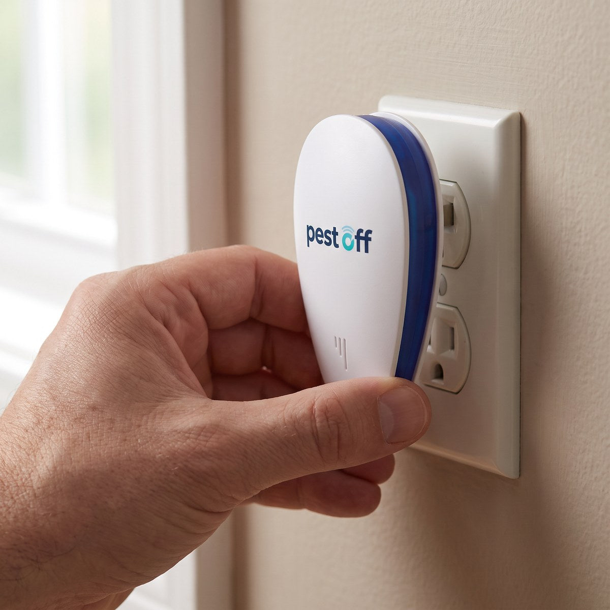 A hand plugging PestOff into a standard American wall outlet